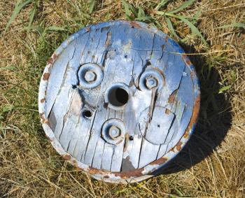 Royalty Free Photo of an Old Round Wooden Cog Lying on the Ground