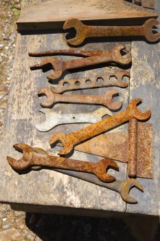Table filled with old rusted wrenches.