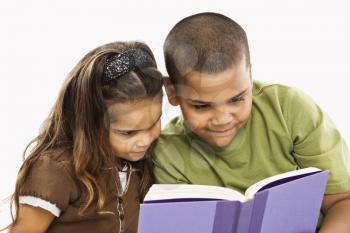 Boy and girl reading book together.