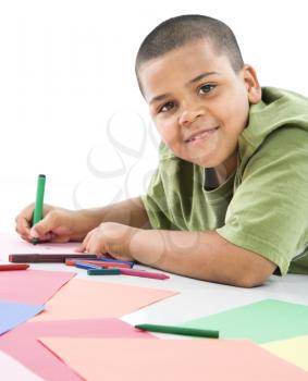 Royalty Free Photo of a Boy Coloring With Crayons