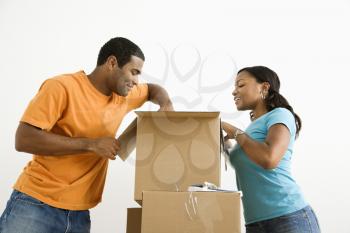 Royalty Free Photo of an African American Couple Packing Cardboard Boxes 