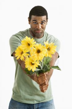 Royalty Free Photo of a Man Holding Out a Bouquet