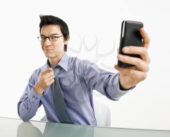 Royalty Free Photo of a Businessman Taking a Photograph of Himself on His Phone