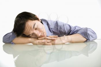 Royalty Free Photo of a Businessman Sleeping on a Desk in the Office