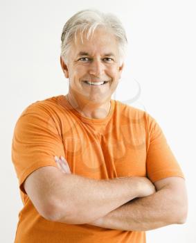 Royalty Free Photo of a Man Standing With Arms Crossed
