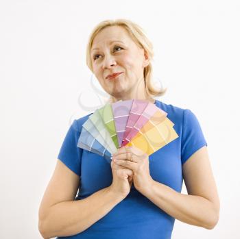 Royalty Free Photo of a Smiling Blonde Woman Holding Paint Swatches