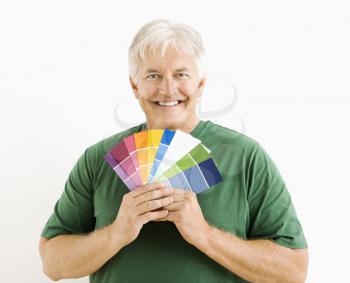 Royalty Free Photo of a Middle-aged Man Holding Paint Swatches