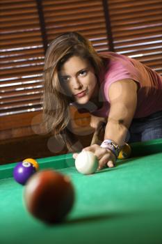 Young Woman Concentrating While Playing Pool. Vertical shot.
