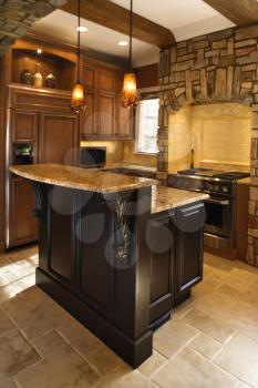 Upscale kitchen interior with stone accents and wood beam ceiling. Vertical shot.