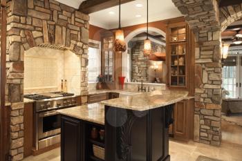 Upscale kitchen interior with stone accents and wood beam ceiling. Horizontal shot.