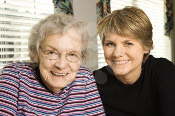 Portrait of an adult woman and senior woman smiling at the camera. Horizontal shot.