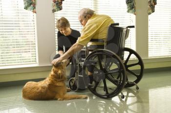 Man in wheelchair with dog.