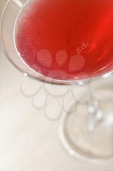 Red colored beverage in a martini glass. Vertical shot.