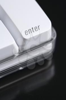 Close up of the enter key on a computer keyboard. Vertical shot.