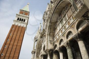 Low angle view of bell tower and facade of St Mark's Basilica. Horizontal shot.