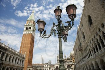 Bell tower and street lamp with facade of St Mark's Basilica. Horizontal shot.