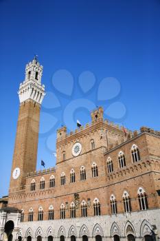 Low angle view of the bell tower of the Palazzo Pubblico, at the Piazzo del Campo, Siena, Italy. Vertical shot.