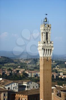 Bell tower of the Palazzo Pubblico, and surrounding buildings, in Siena, Italy. Vertical shot.