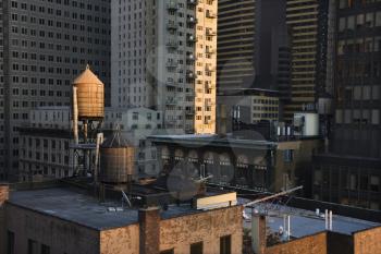 Cropped view of buildings in New York City and rooftop water towers. Horizontal shot.