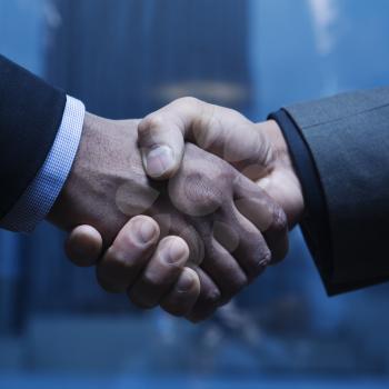 Close-up of Caucasian and African-American businessmen shaking hands. Square format.