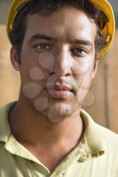 Close up portrait of a male Caucasian construction with a dirty face. He is looking directly into the camera. Vertical shot.