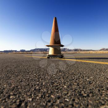 Stacked safety cones on an airport tarmac in a rural landscape. Square shot.