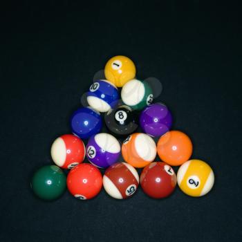 Pool tables arranged in triangle on pool table.
