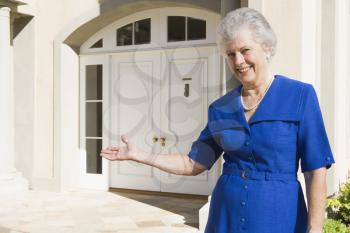 Royalty Free Photo of a Senior Woman Outside Her Home