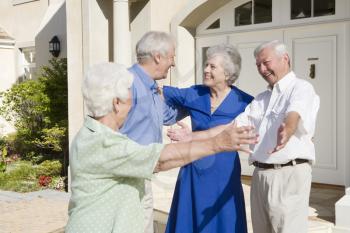 Royalty Free Photo of Two Senior Couples Greeting Each Other