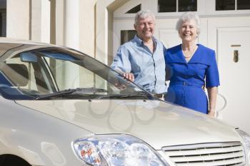 Royalty Free Photo of a Senior Couple Beside a Car