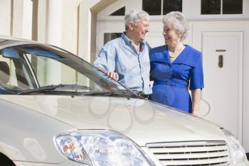 Royalty Free Photo of a Senior Couple Beside a Car