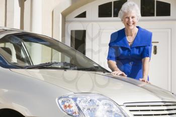 Royalty Free Photo of a Senior Woman Washing Her Car