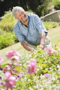 Royalty Free Photo of a Senior Man in a Flower Garden