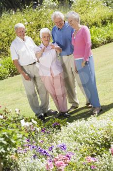 Royalty Free Photo of Two Senior Couples in a Flower Garden