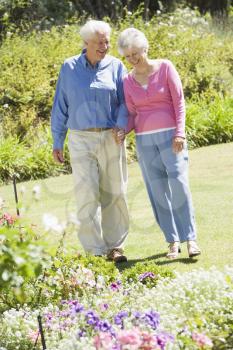 Royalty Free Photo of a Senior Couple in a Flower Garden