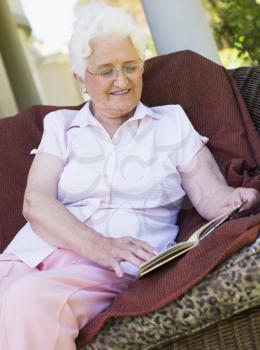 Royalty Free Photo of a Senior Woman Reading Outside