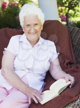 Royalty Free Photo of a Senior Woman Reading Outside