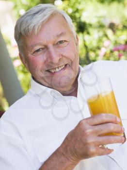 Royalty Free Photo of a Man Drinking Juice Outdoors