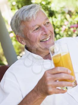 Royalty Free Photo of a Man Outside Drinking Juice