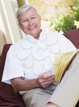 Royalty Free Photo of a Man Reading Outside