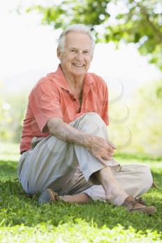 Royalty Free Photo of a Man Sitting on the Lawn