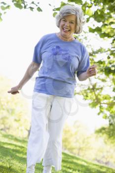 Royalty Free Photo of a Senior Woman Walking in the Park
