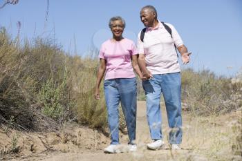 Royalty Free Photo of a Senior Couple Walking on a Trail