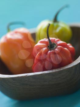 Royalty Free Photo of Scotch Bonnet Chilies In a Wooden Dish