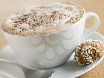 Royalty Free Photo of a Cup of Cappuccino and Amaretto Biscuit