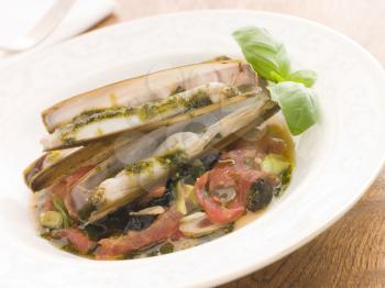 Royalty Free Photo of Razor Clams with Stewed Tomatoes Garlic and Olives