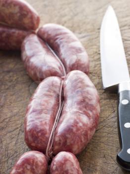 Royalty Free Photo of Sausage Links and a Knife