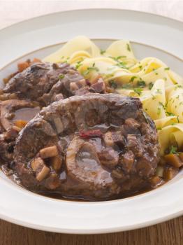 Royalty Free Photo of Osso Bucco Alla Milanaise With Herb Tagliatelle