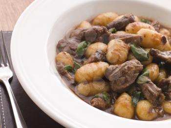 Royalty Free Photo of Oxtail Braised in Red Wine with Basil Gnocchi