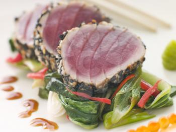 Royalty Free Photo of Seared Yellow Fin Tuna With Sesame Seeds Sweet Fried Pac Choi and Salmon Roe